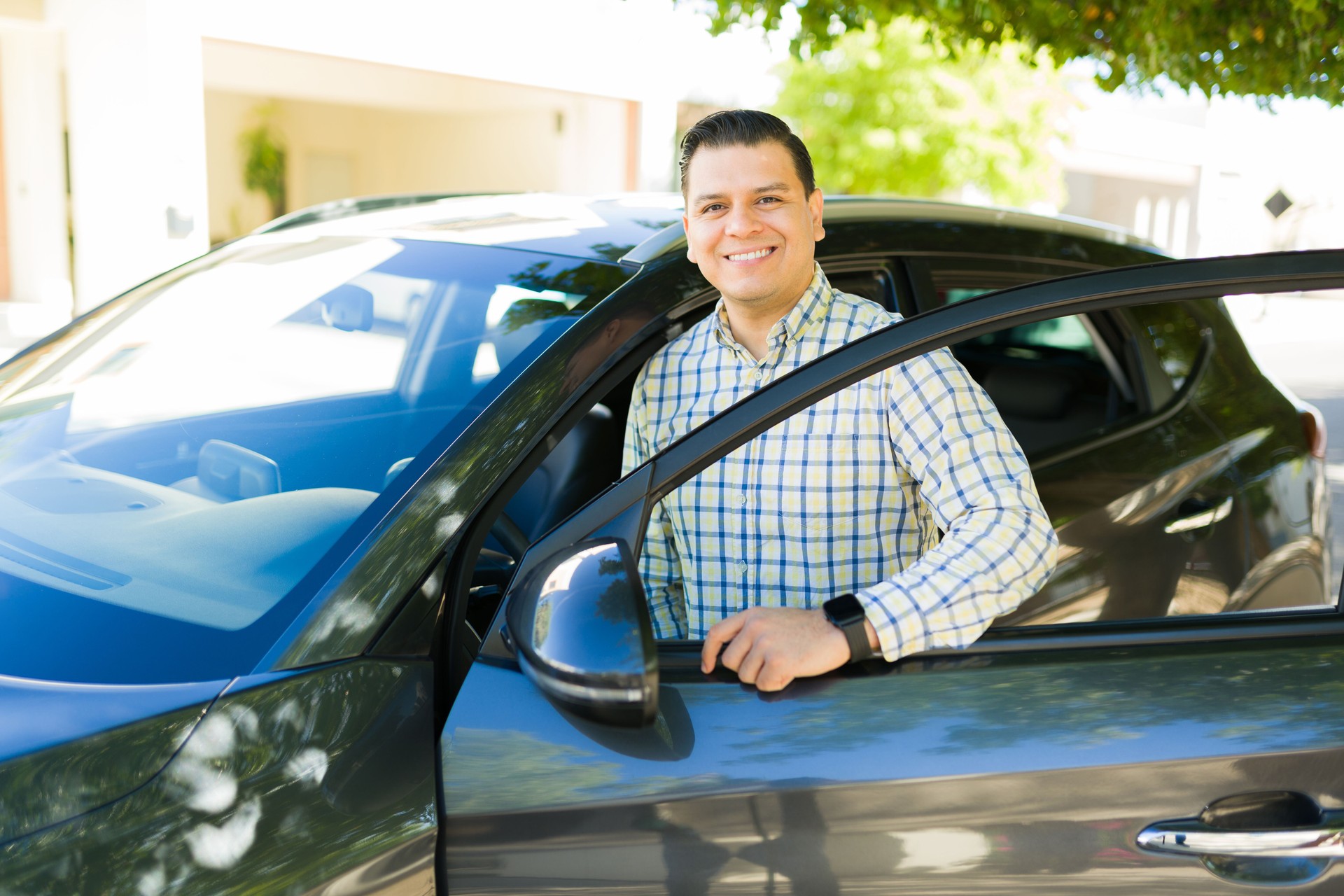 Cheerful rideshare driver waiting to greet passenger and offer convenient and secure transportation services